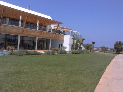 a large building with a large lawn in front of it at Bahia Golf Beach Bouznika appart in Bouznika