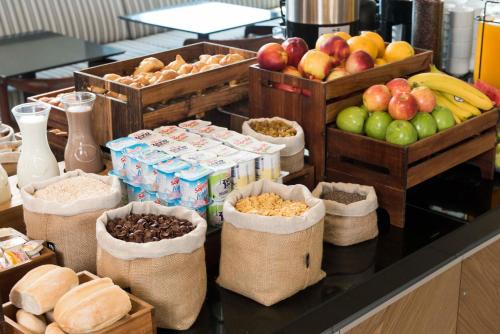 a buffet with baskets of fruit and other food at Holiday Inn Express - Antofagasta by IHG in Antofagasta