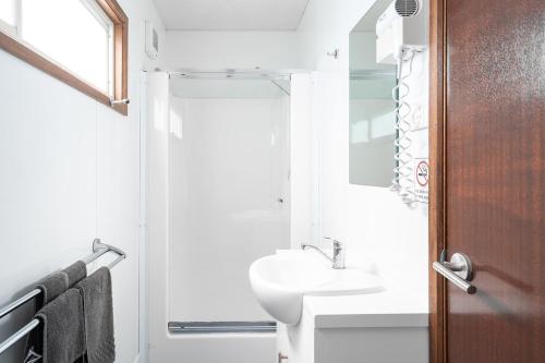 a small bathroom with a sink and a mirror at Gundagai Cabins & Tourist Park in Gundagai