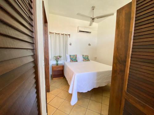 a bedroom with a bed in a room at CABO BOHEMIA Tropical Garden Studios in Cabo San Lucas