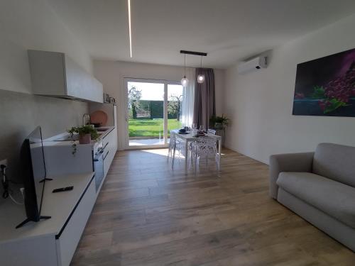 a kitchen and living room with a couch and a table at La Rondinella Apartments in Bardolino