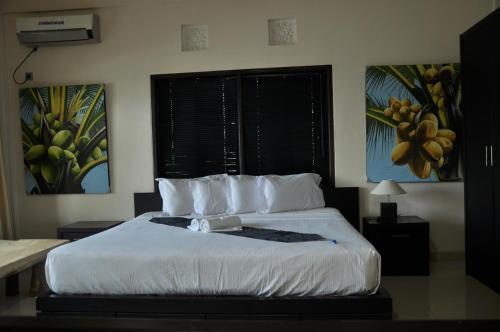 a bedroom with a bed with white sheets and pillows at Crystal Beach Bali in Candidasa