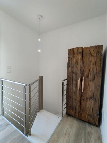 a room with a gate and a wooden door at La Rondinella Apartments in Bardolino
