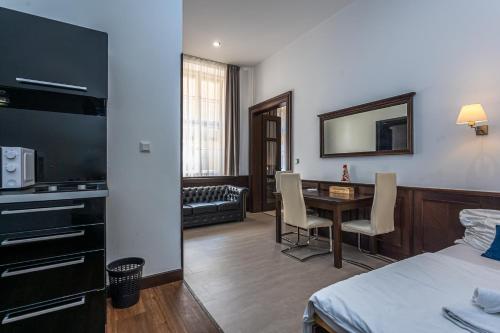 a hotel room with a bed and a table with chairs at Apartrezidence Opletalova in Prague
