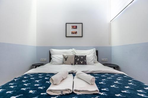a bedroom with a bed with towels on it at Apartrezidence Opletalova in Prague