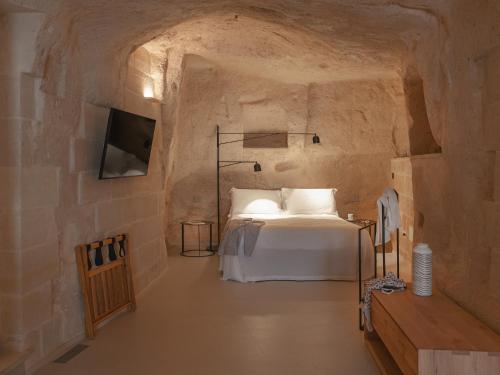 Un pat sau paturi într-o cameră la Palazzo Degli Abati