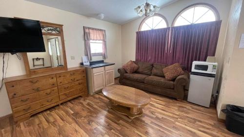 a living room with a couch and a table at Cedar Wood Inn in Deadwood