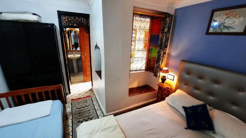 a bedroom with a bed and a mirror and a sink at Riad 112 in Marrakesh