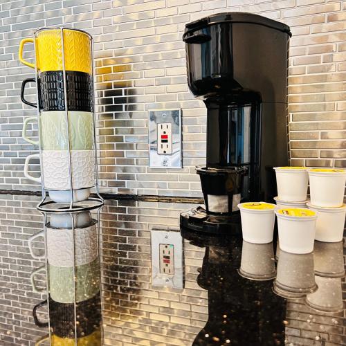 a brick wall with cups and a coffee maker at CocoBay 2BR Condos Near Beach, Galleria Mall, Wilton Manors, Cruise Port in Fort Lauderdale