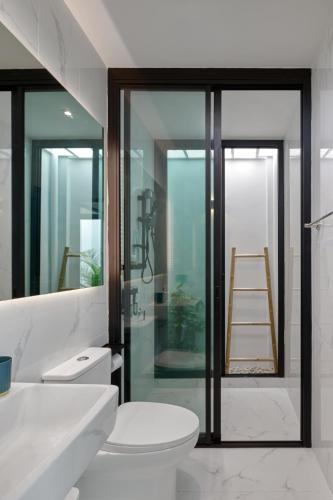 a bathroom with a toilet and a glass door with a ladder at Casa de Yim, Eco Pool Villa in Ao Nang Beach