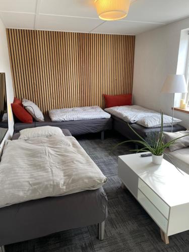 a living room with two beds and a couch at Helts B&B - Helts Guesthouse in Herning