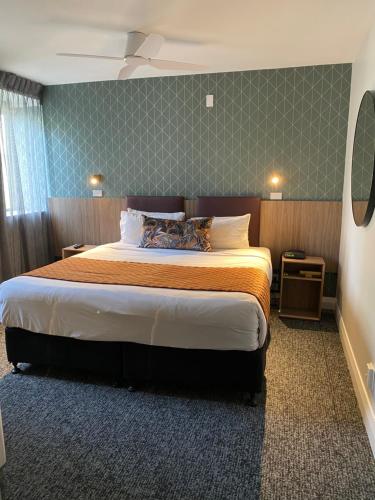 a bedroom with a large bed in a room at Trinity Hotel in Wellington