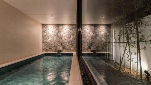 a swimming pool in a building with a pool at Albescent Poolvilla in Gyeongju