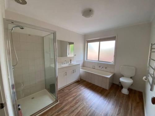 a bathroom with a shower and a sink and a toilet at Valley House - Location Location Location - Comfortable home in the heart of Healesville in Healesville