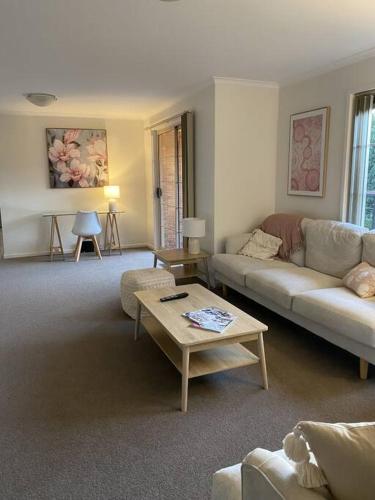 a living room with a couch and a table at Valley House - Location Location Location - Comfortable home in the heart of Healesville in Healesville