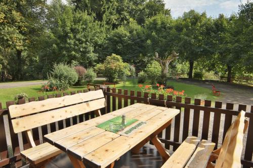 a wooden picnic table with a bottle on top of it at Hotel pod Šikmou Věží in Jičín