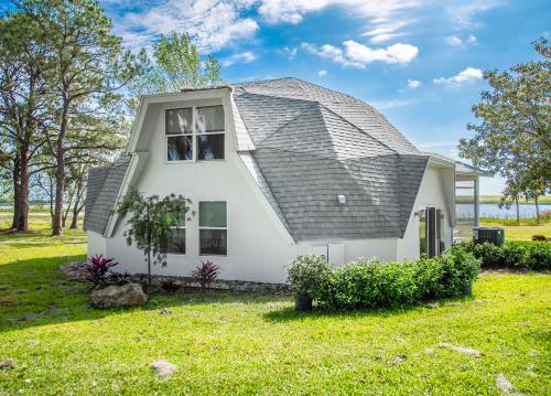 a white house with a gambrel roof at Sumner Lake House 2B in Clermont