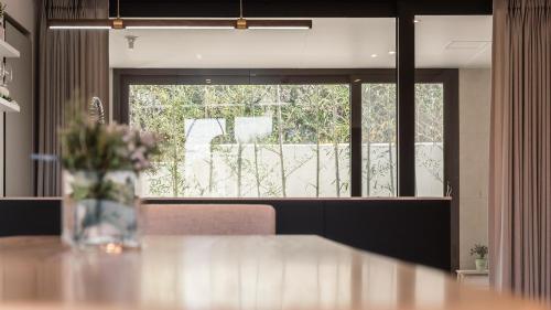 a vase of flowers sitting on top of a table at Albescent Poolvilla in Gyeongju