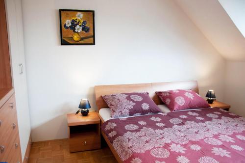 a bedroom with a bed with a purple blanket at Apartments Lipa in Železniki