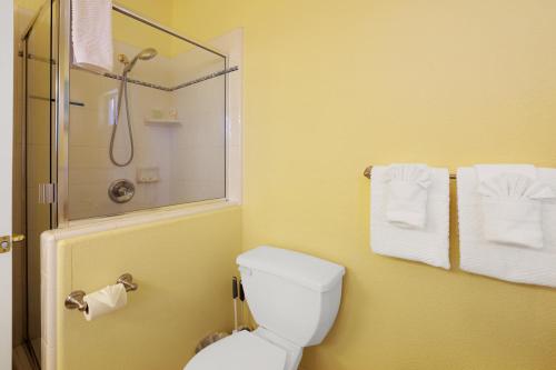 a bathroom with a toilet and a shower with towels at Santo Tomas Getaway - STR0153 in Grover Beach