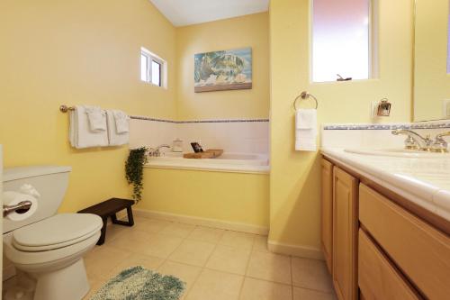 a bathroom with a toilet and a tub and a sink at Santo Tomas Getaway - STR0153 in Grover Beach