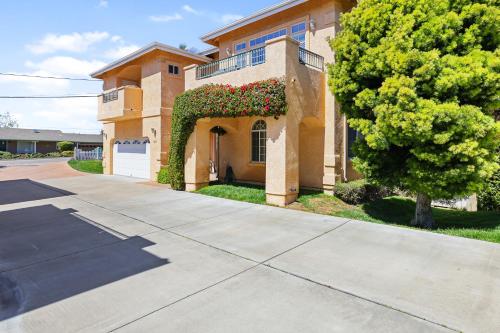 a house with a ivy covered window and a driveway at Santo Tomas Getaway - STR0153 in Grover Beach