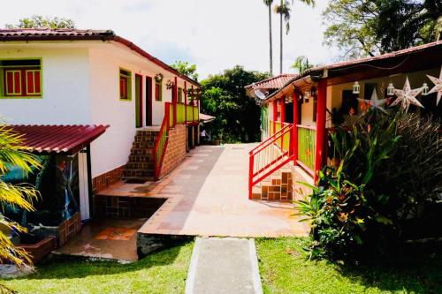 a house with colorful doors and a walkway outside at FINCA HOTEL EL LAUREL - Parque del Café in Montenegro