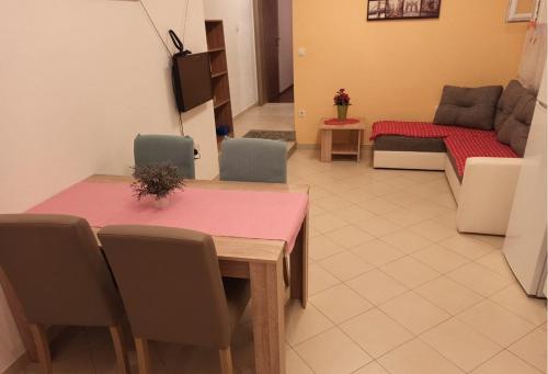 uma sala de estar com duas mesas e um sofá em Apartments Matko-200m from the beach em Kaštela