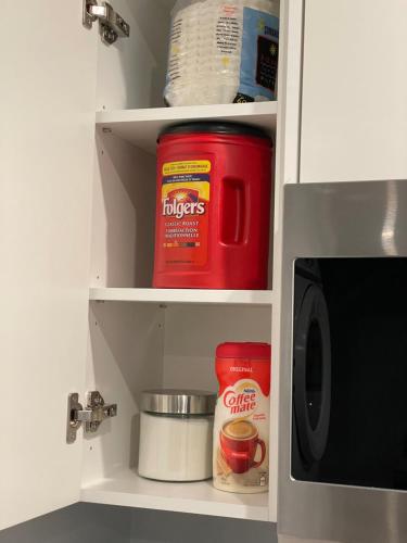 a kitchen cupboard with spices and a microwave at Hamm Suite in Saskatoon