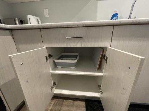a cupboard with a drawer in a kitchen at Hamm Suite in Saskatoon