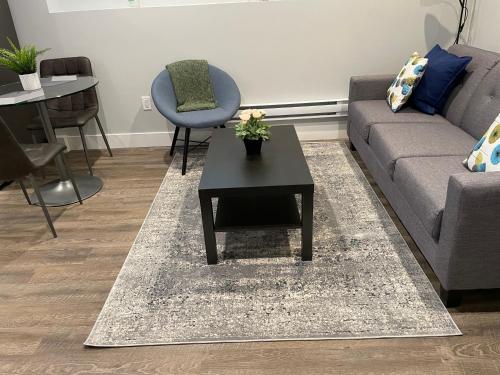 a living room with a couch and a table at Hamm Suite in Saskatoon