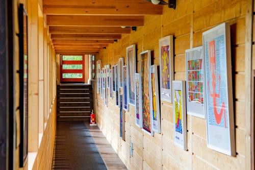 a hallway with paintings on the walls of a building at Niseko HyKrots IKIGAI Village in Rankoshi