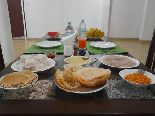 a table topped with plates and bowls of food at Yonara Green Rest in Habarana