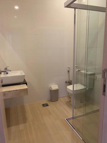 a bathroom with a glass shower and a toilet at 25 homeApart in Encarnación