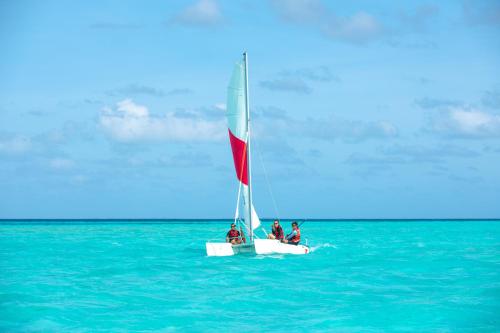 a group of people on a sail boat in the ocean at Radisson Blu Resort Maldives with 50 percent off on Sea Plane round trip 03 nights & above in Fenfushi