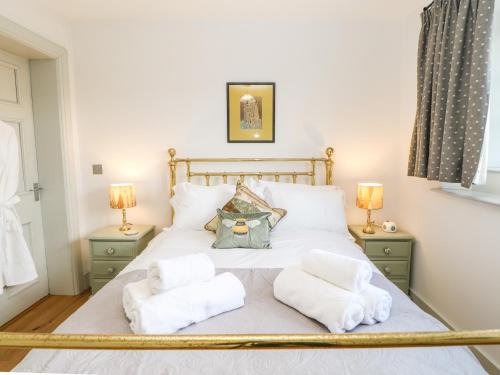a bedroom with a bed with towels on it at Greystead Institute in Hexham