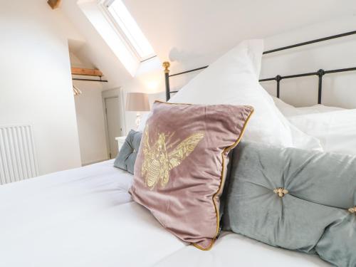 a bedroom with a bed with a butterfly pillow at Greystead Institute in Hexham