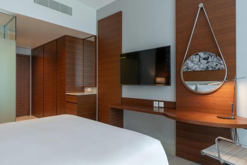 a bedroom with a bed and a flat screen tv at Radisson Blu Hotel, Juba in Juba