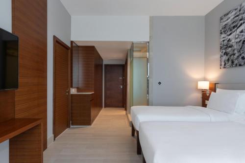 a hotel room with two beds and a television at Radisson Blu Hotel, Juba in Juba