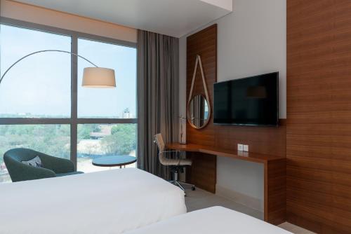 a hotel room with a bed and a flat screen tv at Radisson Blu Hotel, Juba in Juba