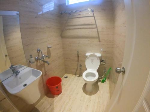 a small bathroom with a toilet and a sink at TGS Dine Inn in Port Blair