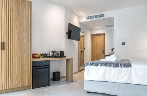 a bedroom with a bed and a desk with a microwave at SAVUS Boutique Hotel in Rethymno Town