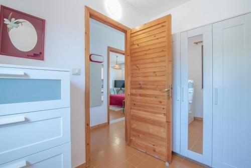 a hallway with a wooden door in a house at La terrazza sul Mare in Agnone Bagni