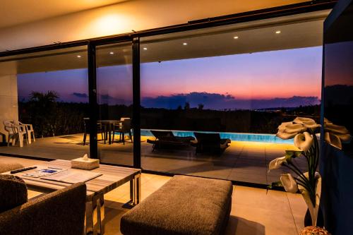 a living room with a view of the sunset at Villa Alyssum in Miyako-jima