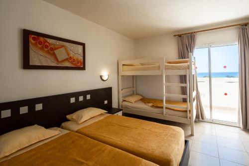 a bedroom with two beds and a bunk bed at Dar Khayam in Hammamet