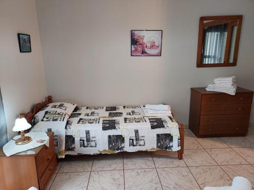 a bedroom with a bed with a quilt on it at 85 sqm Apartments New Panorama ELECTRIC CAR ΦΩΡΤΗΣΗΣ STATION in Paralion astros