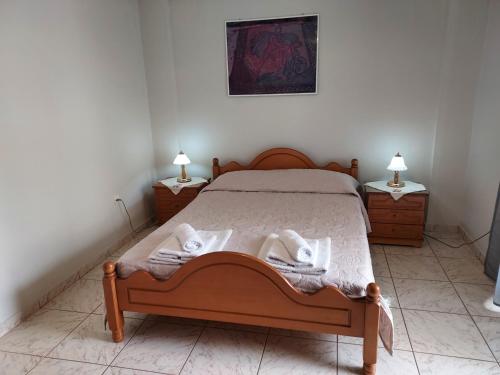 a bedroom with a bed with towels on it at 85 sqm Apartments New Panorama ELECTRIC CAR ΦΩΡΤΗΣΗΣ STATION in Paralion astros