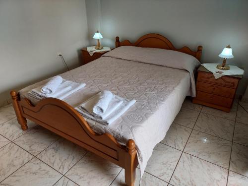 a bedroom with a bed with towels on it at 85 sqm Apartments New Panorama ELECTRIC CAR ΦΩΡΤΗΣΗΣ STATION in Paralion astros