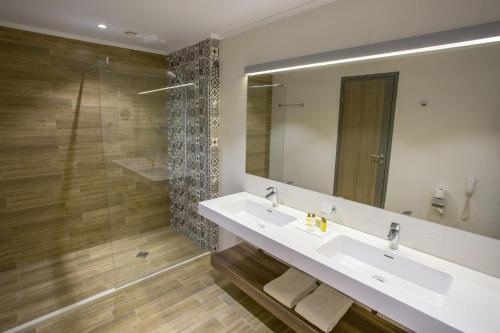 a bathroom with a sink and a mirror at Astoria Hotel All Inclusive- Free parking, Private Beach & Beach Club in Golden Sands