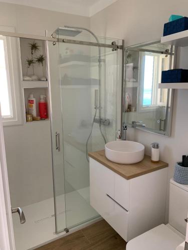 a bathroom with a glass shower and a sink at Primera linea de playa en Torrox Costa in Torrox Costa